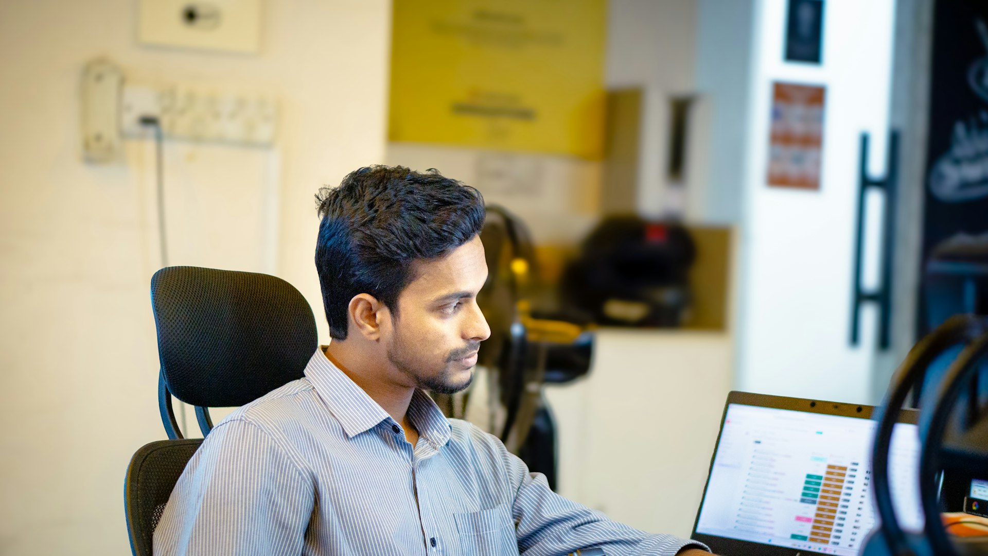 A man sitting in front of a laptop computer